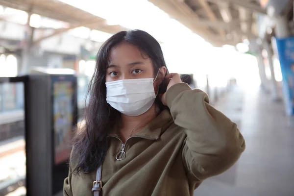 asian woman wearing protection mask standing outdoor