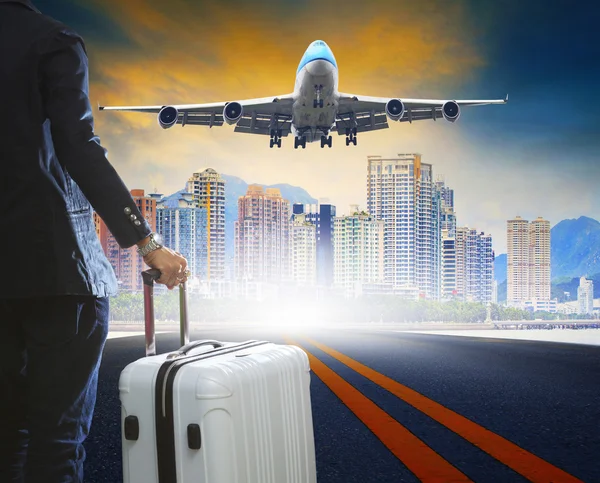 Business man and luggage standing on airport runways with passen