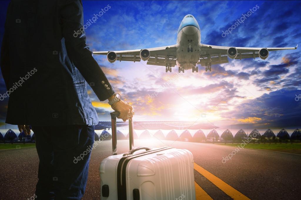 Business man and luggage standing in airport and passenger jet p