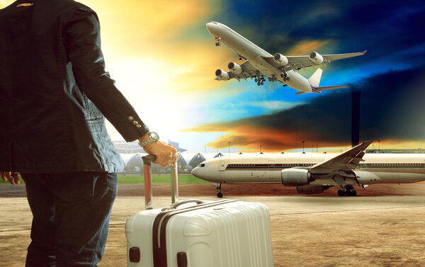 Jet plane flying over runways and beautiful dusky sky with copy