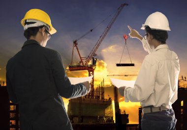Two civil engineer working in building construction site against clipart