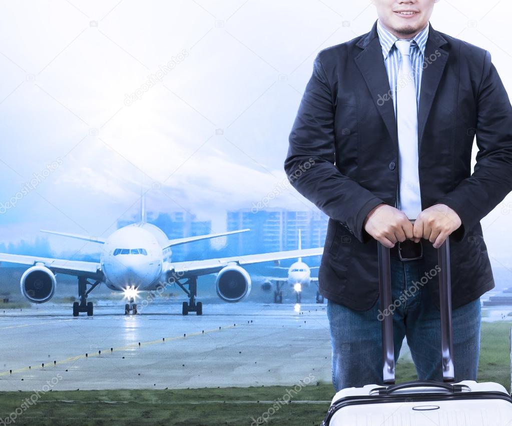 Young man and traveling luggage staning in front of air plane ta