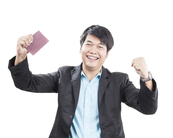 Joven hombre de negocios y libro de pasaportes en la mano actuando cara feliz t — Foto de Stock