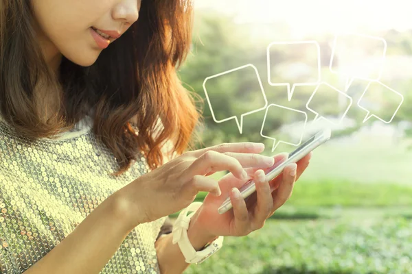 Beautiful woman playing and touching on smart phone screen in ou — Stock Photo, Image