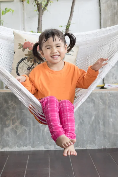 Portrait of children toothy smiling and relaxing in clothes crad — Stock Photo, Image