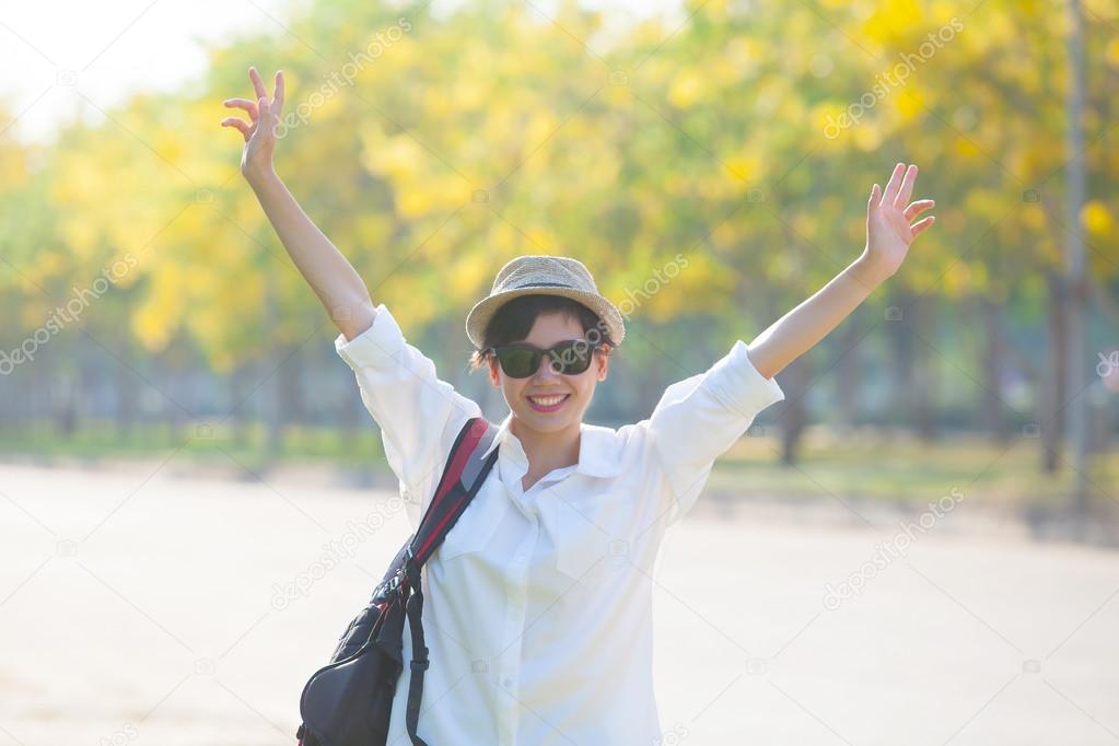 young beautiful woman wearing white shirts ,straw hat and sun gl