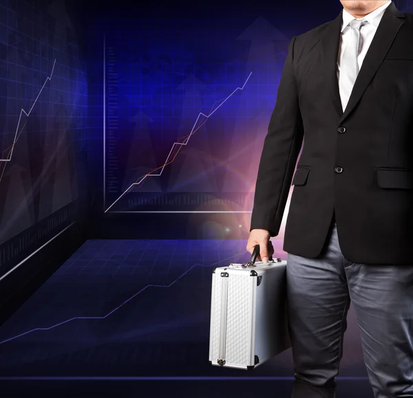 Business man holding metal strong breifcase standing against ind — Stock Photo, Image