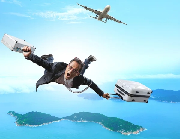 Crazy business man flying from passenger plane with briefcase an — Stock Photo, Image