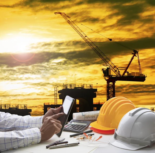 Hand of architect working on computer tablet  with construction — Stock Photo, Image