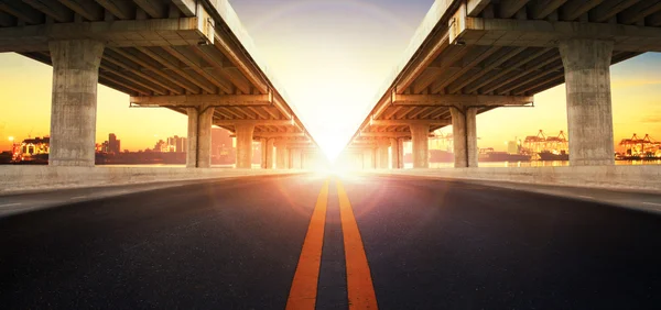 Sun rising behind perspective on bridge ram construction and asp — Stock Photo, Image