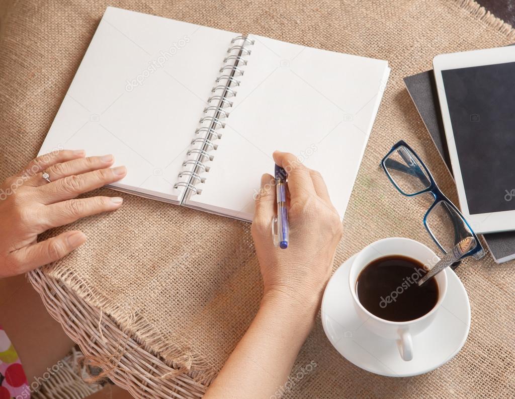 woman writing shot memories note on white paper with relaxing ti