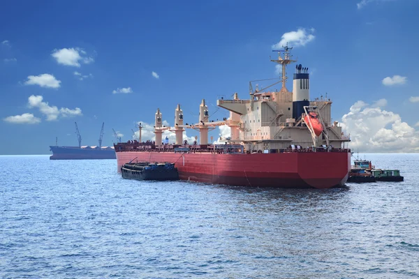 Container boat loading goods over clear blue water sea use for v — Stock Photo, Image