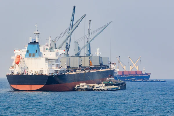 Container boat loading goods over clear blue water sea use for v — Stock Photo, Image