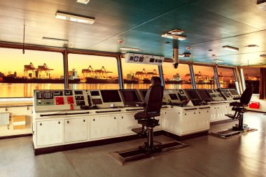 wheelhouse control board of modern industry ship approaching to  clipart