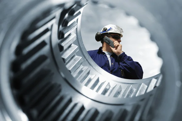 Engineer, worker inside large cogwheel axle — Stock Photo, Image