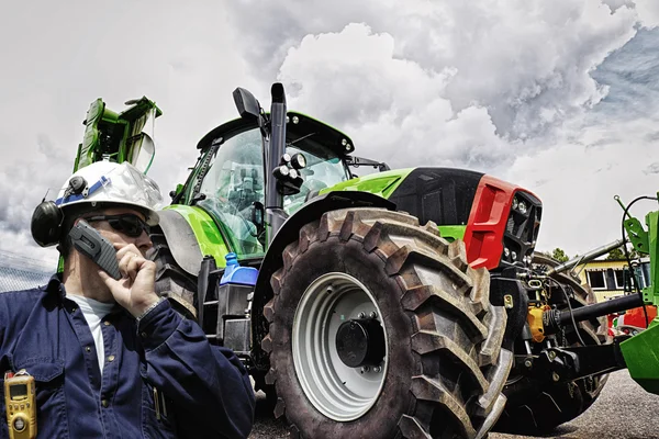 Modern farmer with large tractor Stock Photo