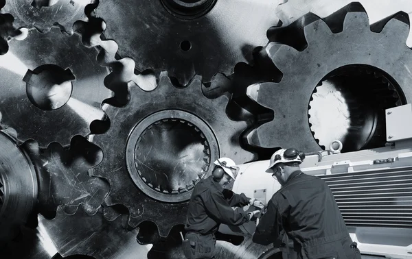 Engineers with large cogwheels — Stock Photo, Image