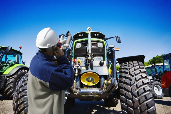 Farming tractor and mechanic Stock Image