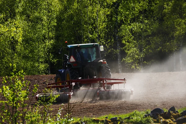 Alter Traktor pflügt bei Sonnenuntergang — Stockfoto