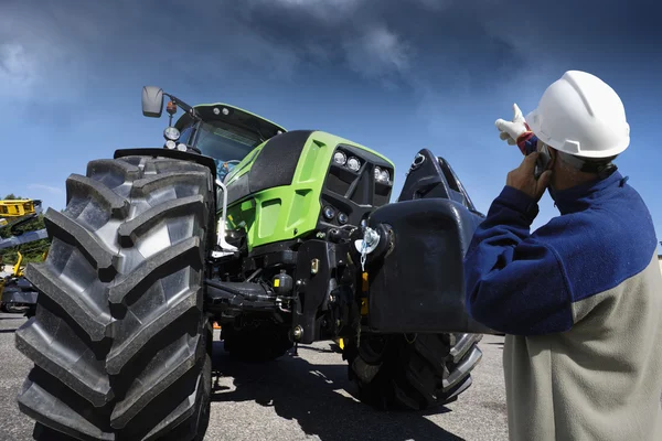 Farming tractor and modern farmer Royalty Free Stock Photos