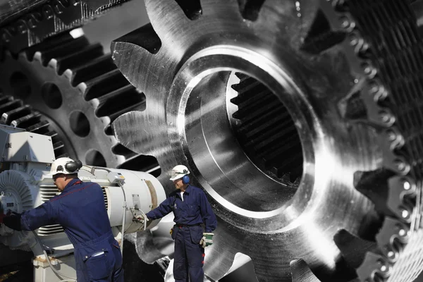 Engineers and mechanics with cogwheels and gears — Stock Photo, Image