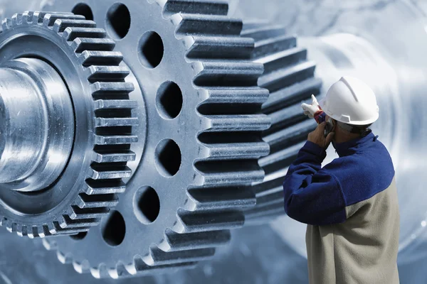 Engineer, worker pointing at giant cogwheels machinery — Stock Photo, Image