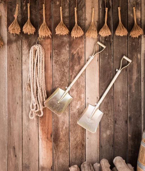 Two shovels on vintage wooden wall — Stock Photo, Image