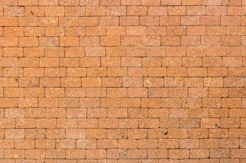 Red color of decorative laterite stone wall surface Stock Photo by