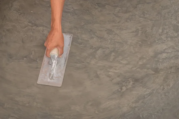 Hand using steel trowel to finish Polished wet concrete surface — Stock Photo, Image