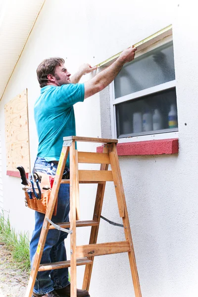 Contractor Measures Window Stock Photo