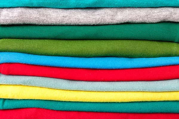 Clothes in the stack as a background — Stock Photo, Image