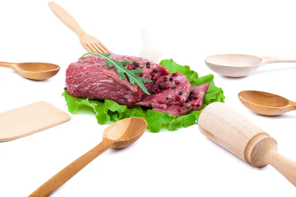 Fresh raw meat and wooden kitchen utensils. — Stock Photo, Image