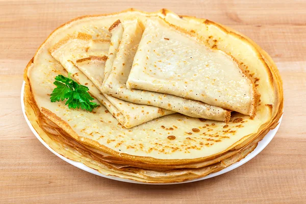Pancakes in the plate on a wooden background — Stock Photo, Image