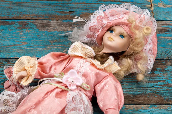 Broken doll on a wooden floor. — Stock Photo, Image