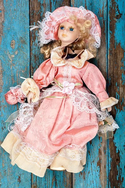 Broken doll on a wooden floor. — Stock Photo, Image