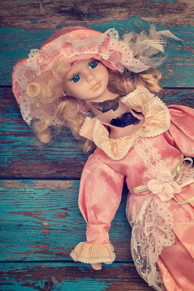 Broken doll on a wooden floor. — Stock Photo, Image