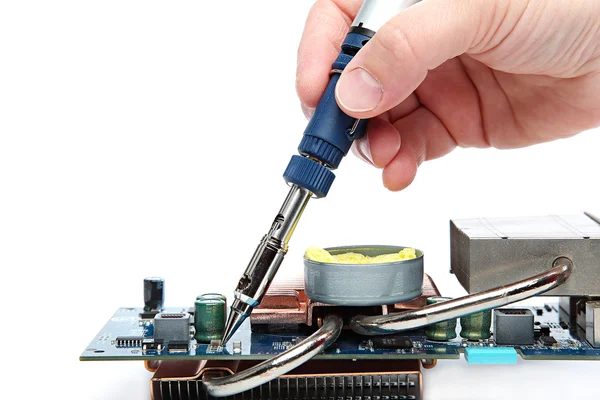 Soldering iron in hand and electric board. — Stock Photo, Image