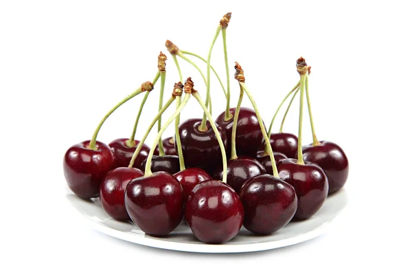 Fresh cherries in a saucer on a white background. — Stock Photo, Image