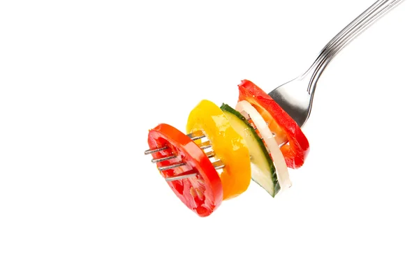 Slices of fresh vegetables in oil on a fork. — Stock Photo, Image