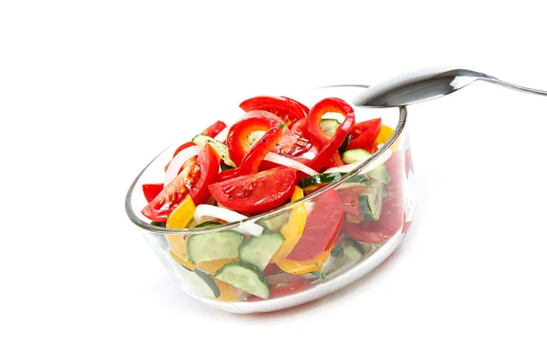 Fresh vegetable salad in a glass dish on a white background. — Stock Photo, Image