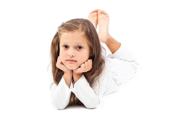 Little cute girl lying head leaning on hands. — Stock Photo, Image