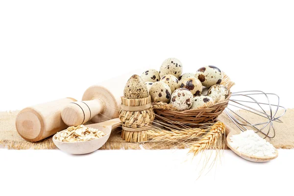 Kwartel eieren, meel en kookgerei op doek op witte backgr — Stockfoto