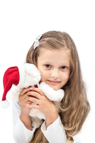 Little cute girl with Christmas bear in hands. Royalty Free Stock Photos