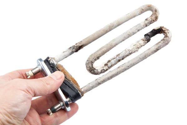 Damaged heating element of the washing machine in a hand. — Stock Photo, Image