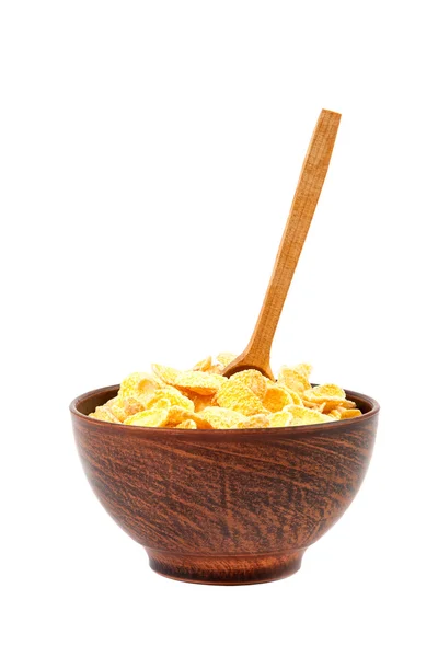 Cornflakes in bowl and wooden spoon. — Stock Photo, Image