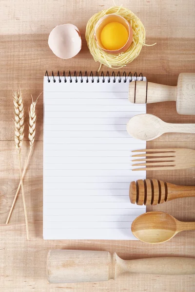 Baking ingredients for cooking and notebook for recipes on a woo — Stock Photo, Image