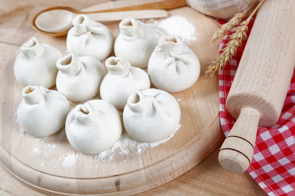 Baking ingredients for cooking manti dumplings on a wooden board Royalty Free Stock Photos