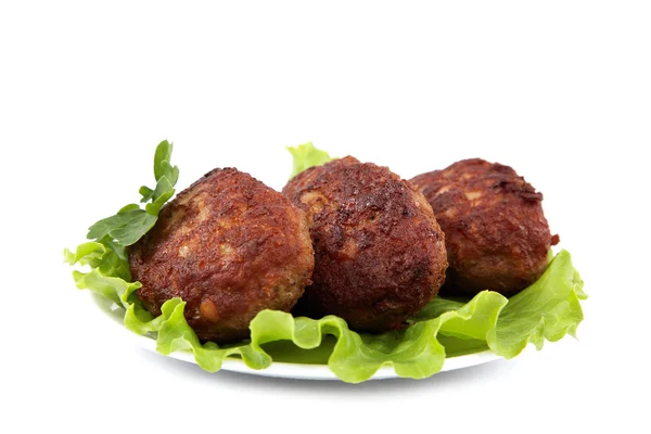 Meat patties with fresh lettuce on a white background. — Stock Photo, Image