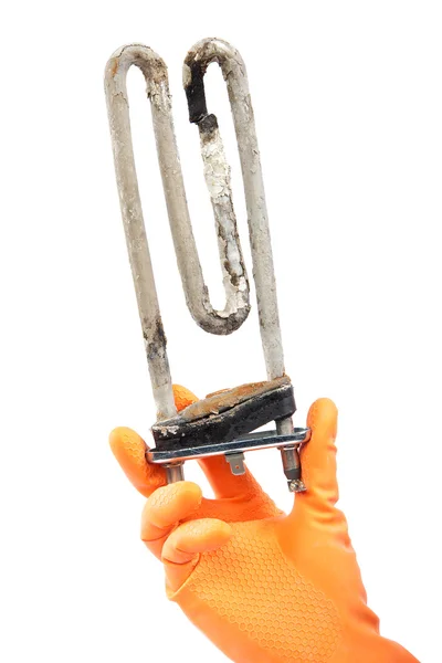 Damaged heating element of the washing machine in hand with rubb Stock Photo