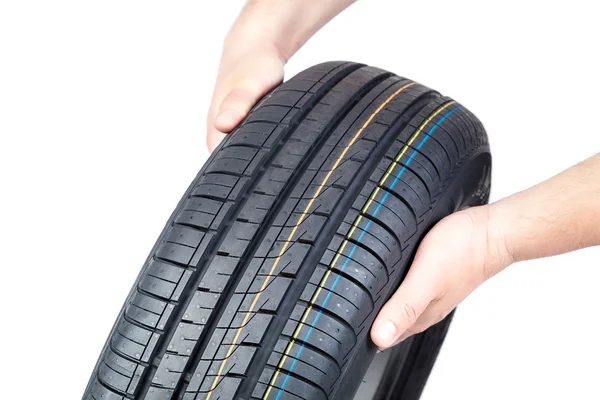 Car tire in the hands on white background. — Stock Photo, Image